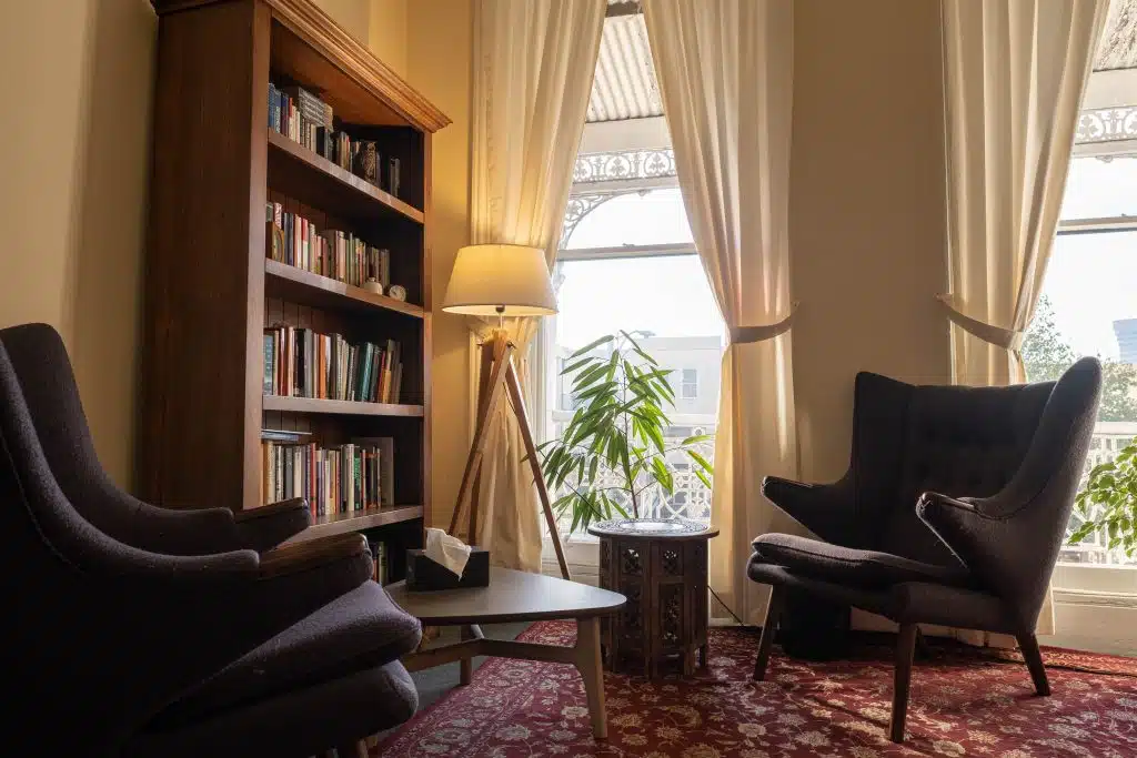 An image of two empty chairs in a softly lit room at Dynamic Psychotherapy Melbourne, for one of their Melbourne therapists and a client.